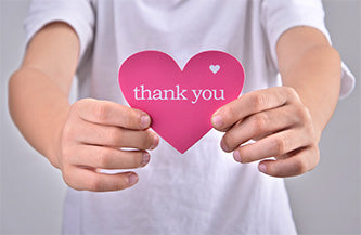 holding thank you note written on heart