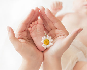 baby feet being help in hand 